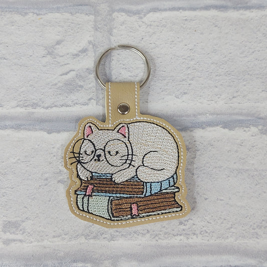 Handmade Vinyl Keyring - Cat sat on Books