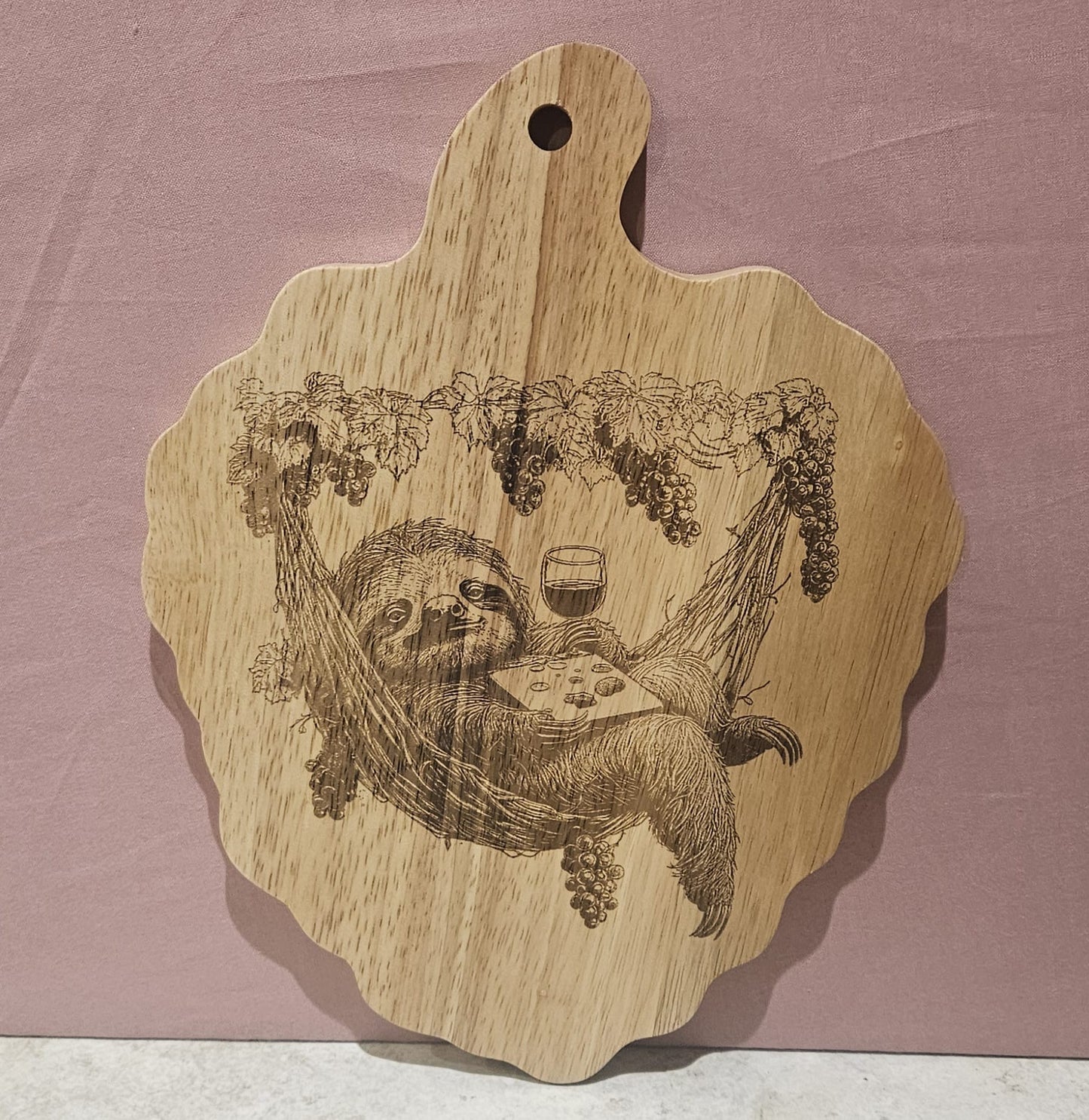 Laser engraved Sloth in Hammock design - Hevea Wood Chopping Board Grape Shape